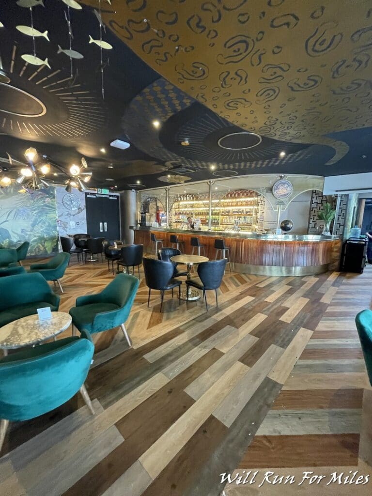 a room with a bar and chairs