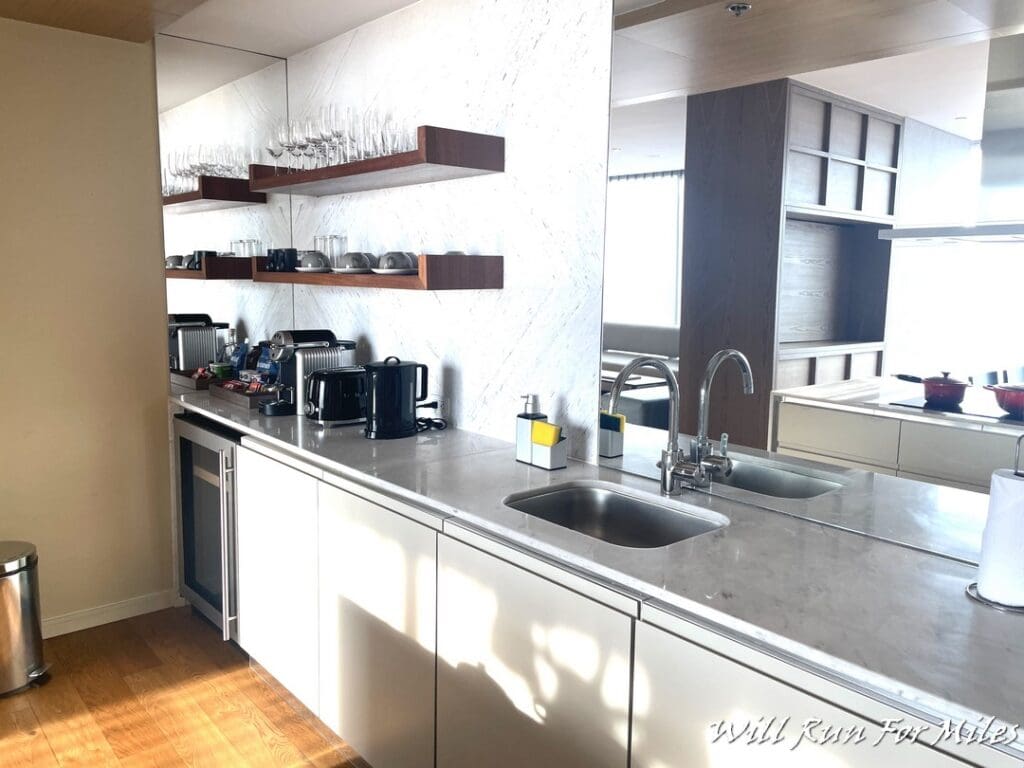 a kitchen with a sink and shelves