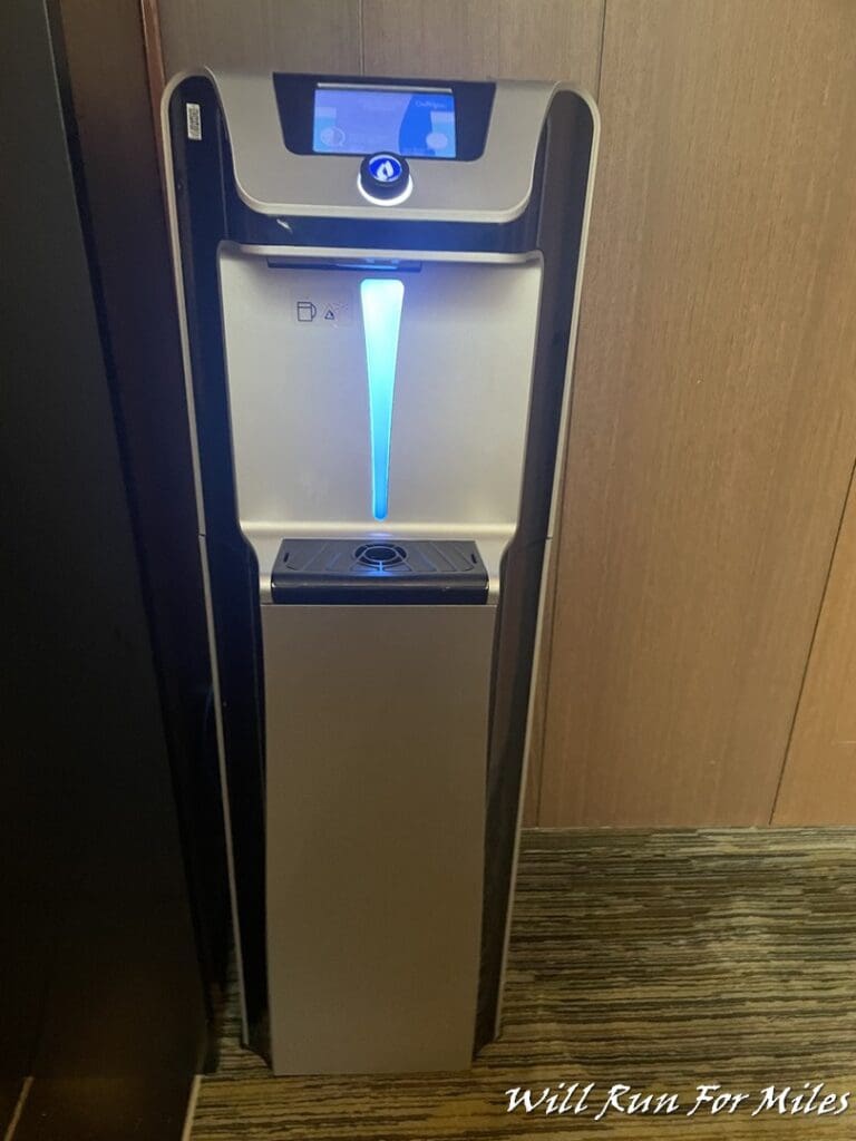 a water dispenser with a screen and a touch screen