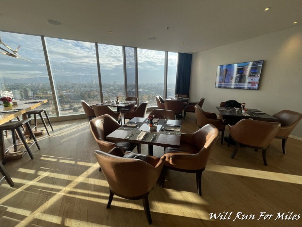 a room with tables and chairs and a television