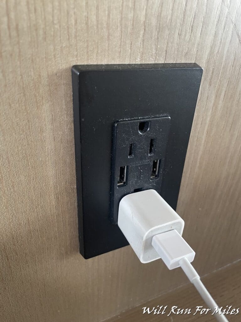 a black electrical outlet with a white plug in