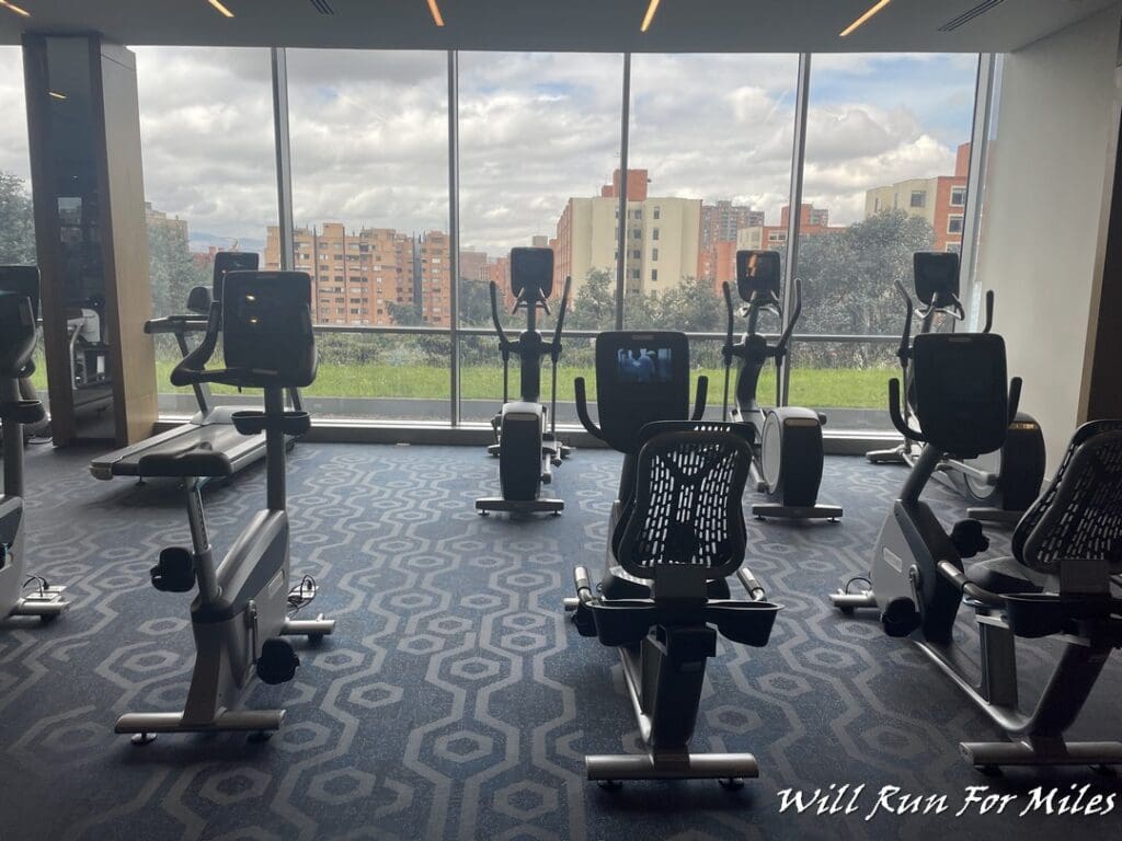 a room with exercise bikes and a large window