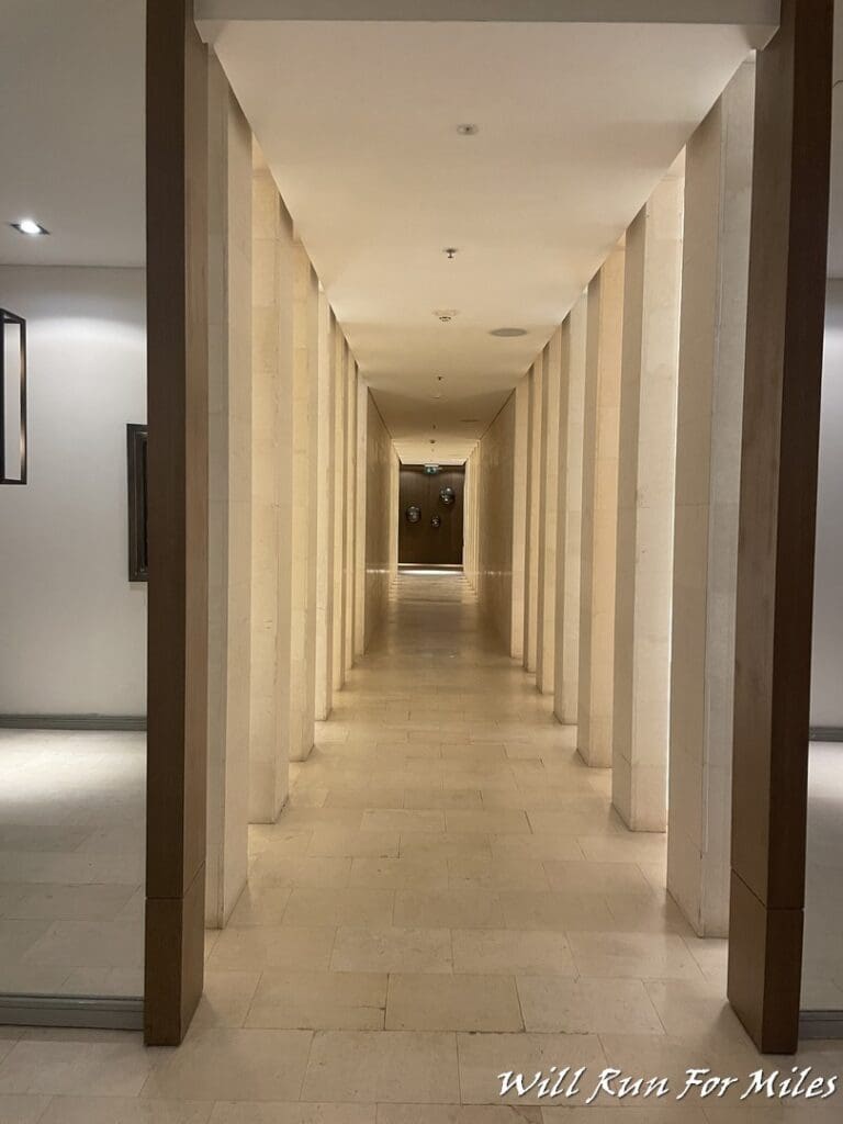 a hallway with columns and lights