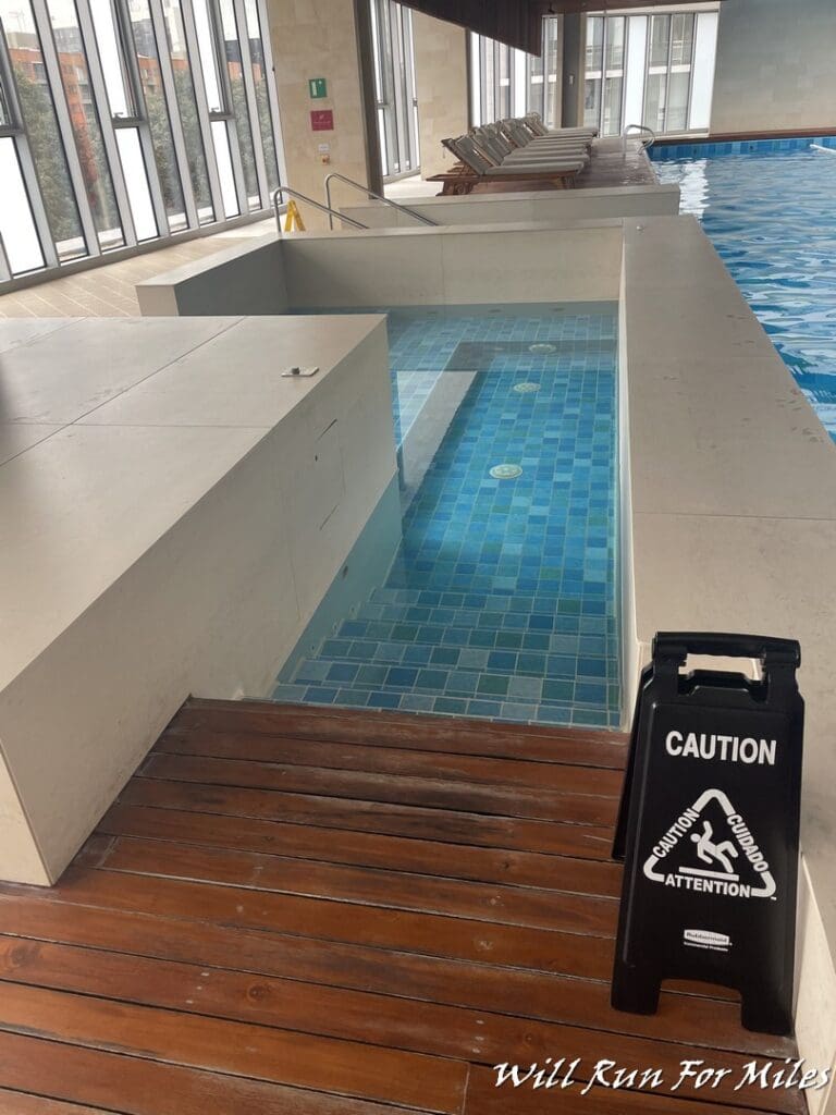 a pool with a caution sign