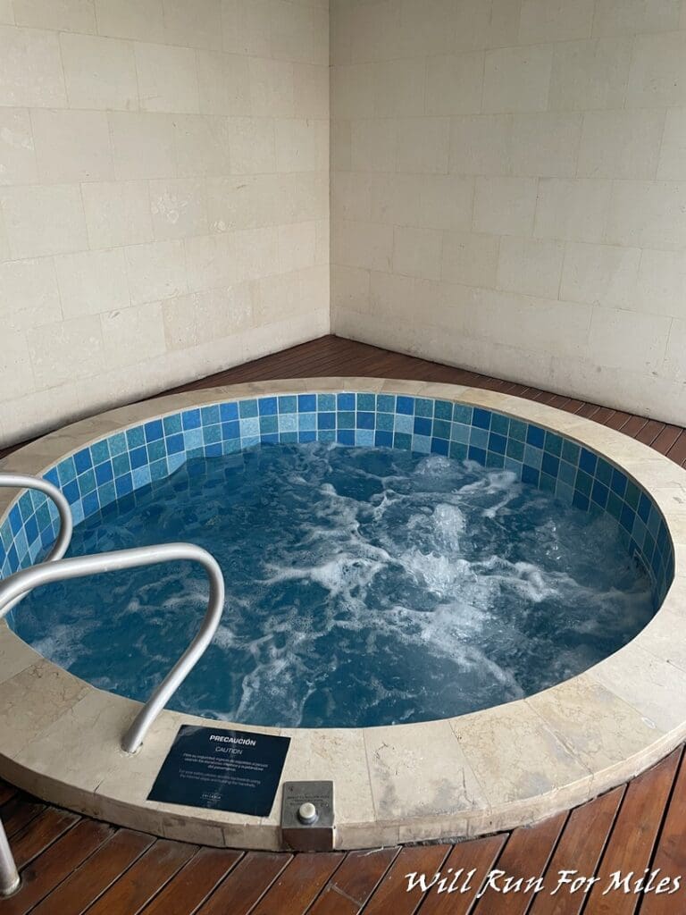 a hot tub with a metal railing