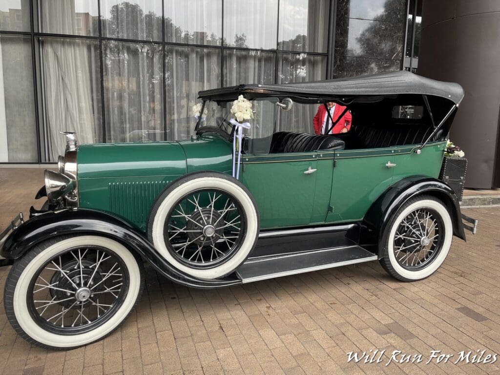 a green car with white tires