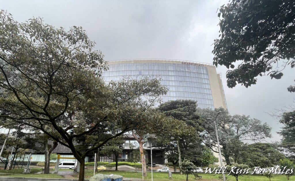 a building with trees and cars in the background