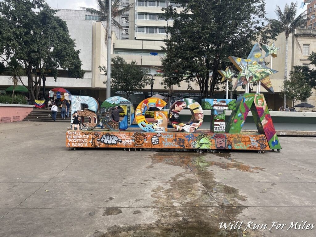 a large sign with graffiti on it