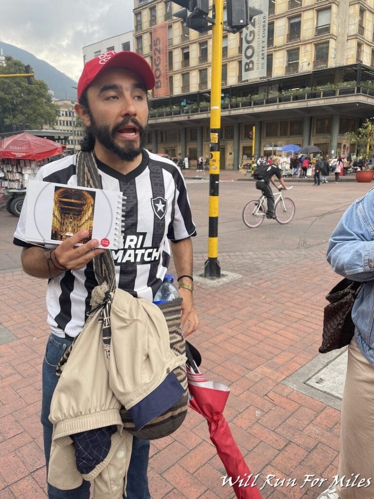 a man in a red hat holding a book and a book