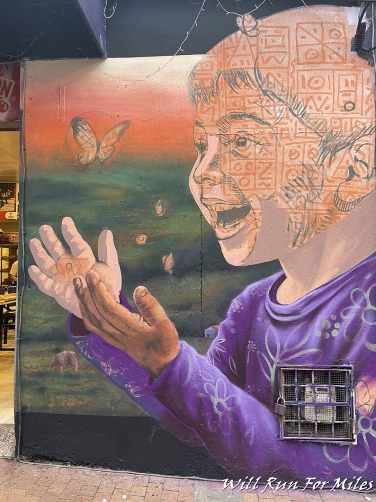 a mural of a child and butterflies