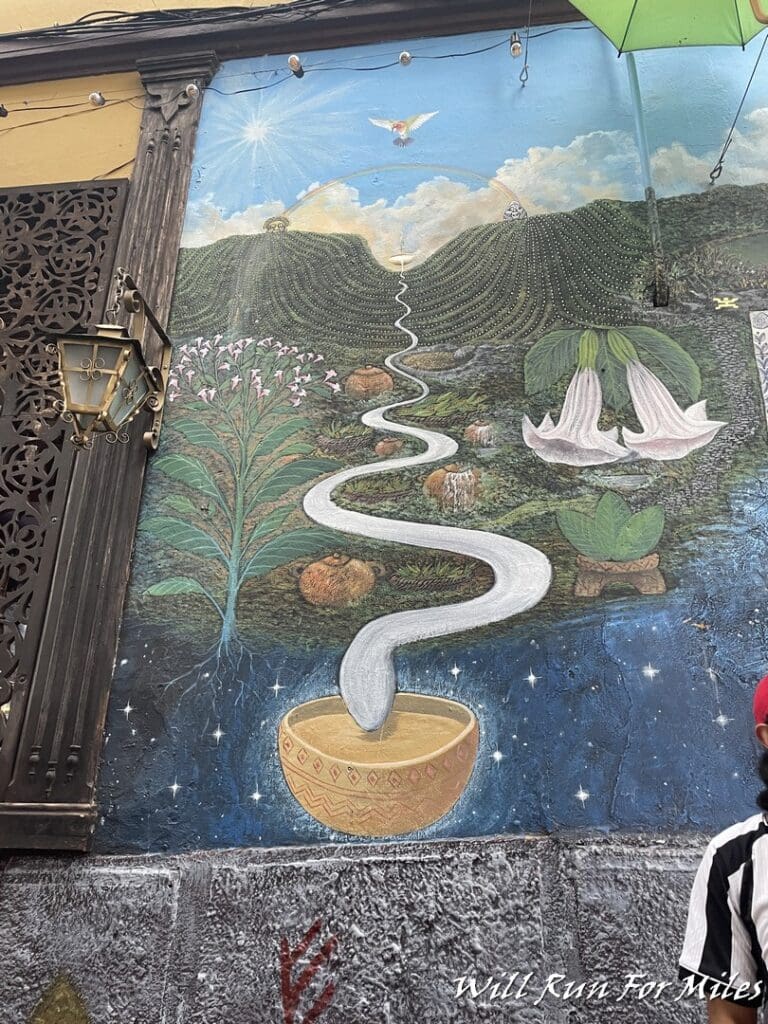 a mural of a landscape with a stream of milk and flowers