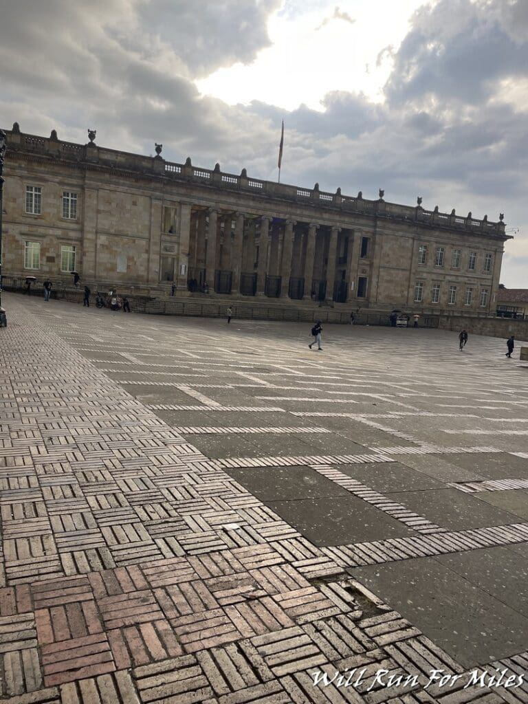 a stone building with columns and a stone walkway