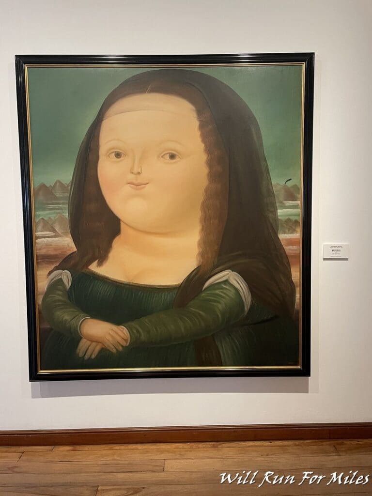 a painting of a woman in a black frame