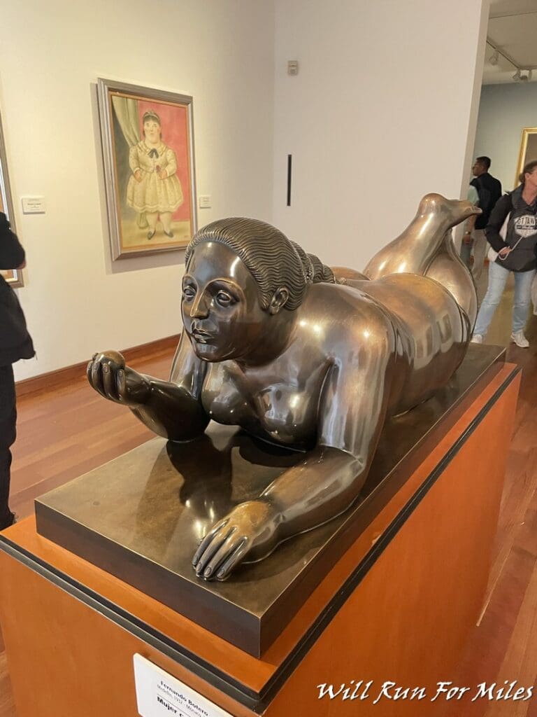 a statue of a woman lying on a pedestal